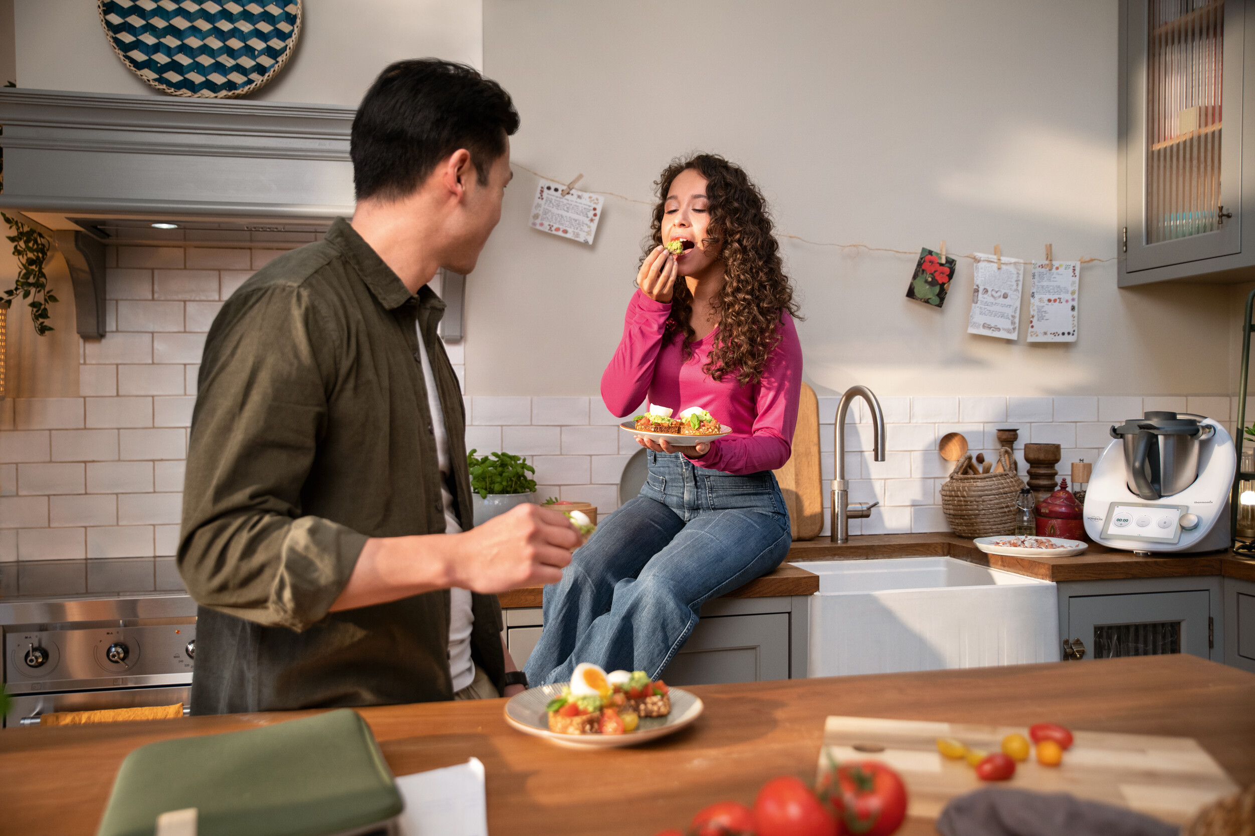 Couple enjoying a homemade meal in a cozy kitchen.